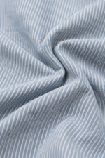 Close-up of blue and off-white striped cotton fabric texture