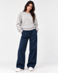 Model wearing the light grey keyhole back sweatshirt with dark wide-leg pants