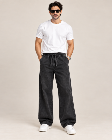 Male model wearing BuxStyle charcoal wide leg denim pants with elasticated drawstring waist