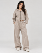 Woman wearing BuxStyle stone acid wash tracksuit set with cropped zip hoodie and relaxed baggy sweatpants