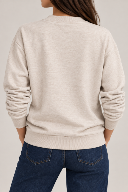 Close-up of oatmeal beige sweatshirt showing ribbed V-neck and subtle lurex texture